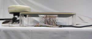 The prototype device showing the cylindrical ladder coil and the patient table with face cushion. The transducer is not shown.