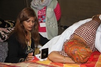 Clinical services were strictly segregated by gender during ASE's Focus on India event. Sonographer Sue Maisey is shown performing an echocardiogram in the women's clinic. Image courtesy of ASE.