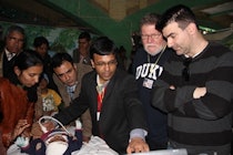 U.S. and Indian participants in the Focus on India project watch program organizer Dr. Partho Sengupta perform an echocardiogram during the mass screening in Sirsa, India, on January 25. Image courtesy of ASE.