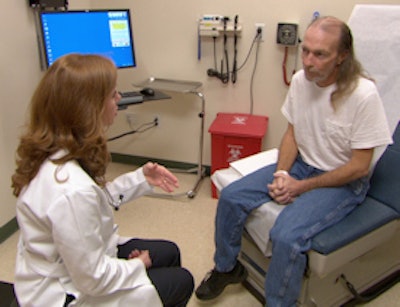 Thoracic surgeon Dr. Theolyn Price meets with screening patient Richard Phillips as part of the lung cancer screening program.