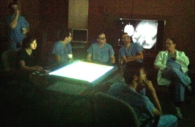 Dr. David Baskin (seated in lab coat at right) and residents review a case in the cave. Baskin is director of the neurosurgery residency training program at the Houston Methodist Hospital Neurological Institute, a professor of neurosurgery at Weill Cornell Medical College and Houston Methodist Hospital, and a professor of pharmacology and engineering at the University of Houston. All images courtesy of Dr. Brian Butler and Shirley Clark.