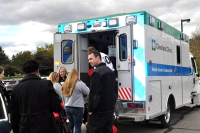 EMTs and stroke unit personnel move a patient into the mobile stroke unit. Image courtesy of Dr. Muhammad Shazam Hussain.