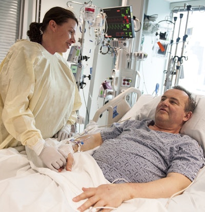 Recovering patient Thomas Manning with nurse practitioner Heather Park of MGH Plastic Surgery. Image courtesy of MGH.