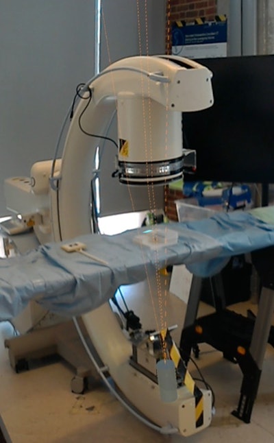 A HoloLens screen capture in one-view mode of the surgical suite showing virtual lines pinpointing a targeted area on a marker. All images courtesy of Mathias Unberath, PhD.