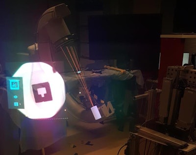 A fluoroscopy monitor contains x-ray images of a marker (left) that is surrounded by 3D virtual guidance lines on an operating table (center).