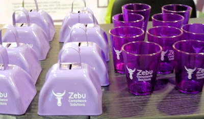 Table with rows of cowbells and shot glasses