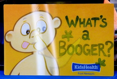 Mouse pad showing a baby picking its nose with text reading, What