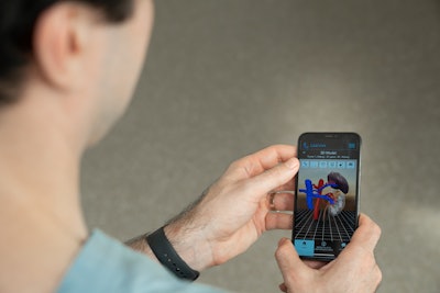 Dr. Joseph Shirk viewing a patient-specific 3D virtual reality kidney model on a smartphone.