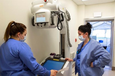 Natalie Conrad, right, and Katarina Kunkel, radiologic technologists with Penn State Health Milton S. Hershey Medical Center, set up the portable x-ray machine. Image courtesy of Penn State Health.