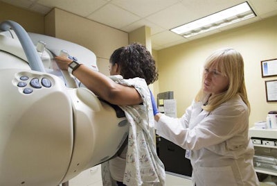 A radiology technician helps prepare a patient for screening mammography at the University of Washington Medical Center - Roosevelt in Seattle. Image courtesy of UW Medicine.