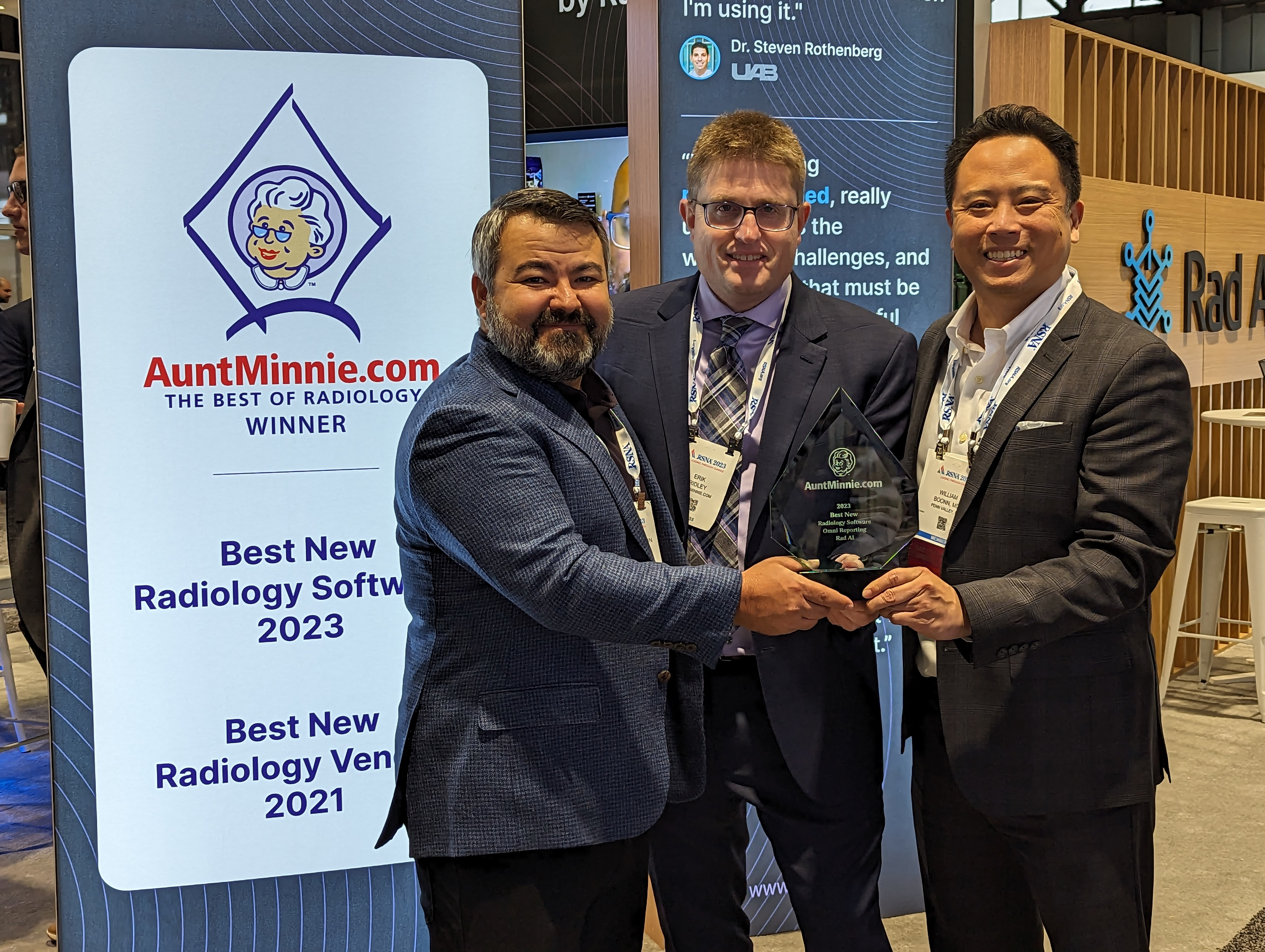 Rad AI CEO Doktor Gurson and Chief Michael Officer William Boonn, MD, receive the 2023 Minnie for Best New Radiology Software from AuntMinnie.com Editor in Chief Erik Ridley. Rad AI won the Minnie for its Omni Reporting software.