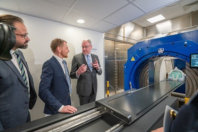 Prof. Aswin Hoffmann, PhD, (right) presents the prototype for MRI-guided proton therapy to Saxony's Minister-President Michael Kretschmer (center) and Saxon State Minister for Science Sebastian Gemkow (left). Photo used with permission, copyright UKD / Michael Kretzschmar