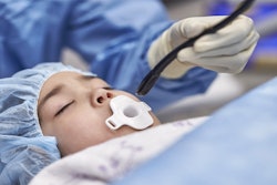 A clinician using the Mini TEE 3D transducer on a pediatric patient.