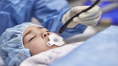 A clinician using the Mini TEE 3D transducer on a pediatric patient.