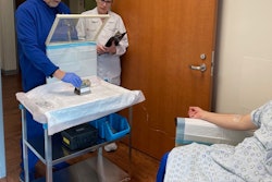Team members from the theranostics clinic under University of Texas Health Science Center at San Antonio's Department of Radiology show one aspect of a Pluvicto infusion treatment. The L block lead shield over the syringe helps protect certified nuclear medicine technologist James Johnson (left), and nuclear radiologist Penny Vroman, MD (right), from radiation emitted by the drug. (Photo courtesy of UT Health San Antonio Department of Radiology)