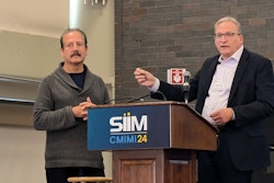 Eliot Siegel, MD, (left) and Charles Kahn Jr., MD, discuss Kahn's presentation at CMIMI 2024.