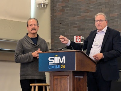 Eliot Siegel, MD, (left) and Charles Kahn Jr., MD, discuss Kahn's presentation at CMIMI 2024.