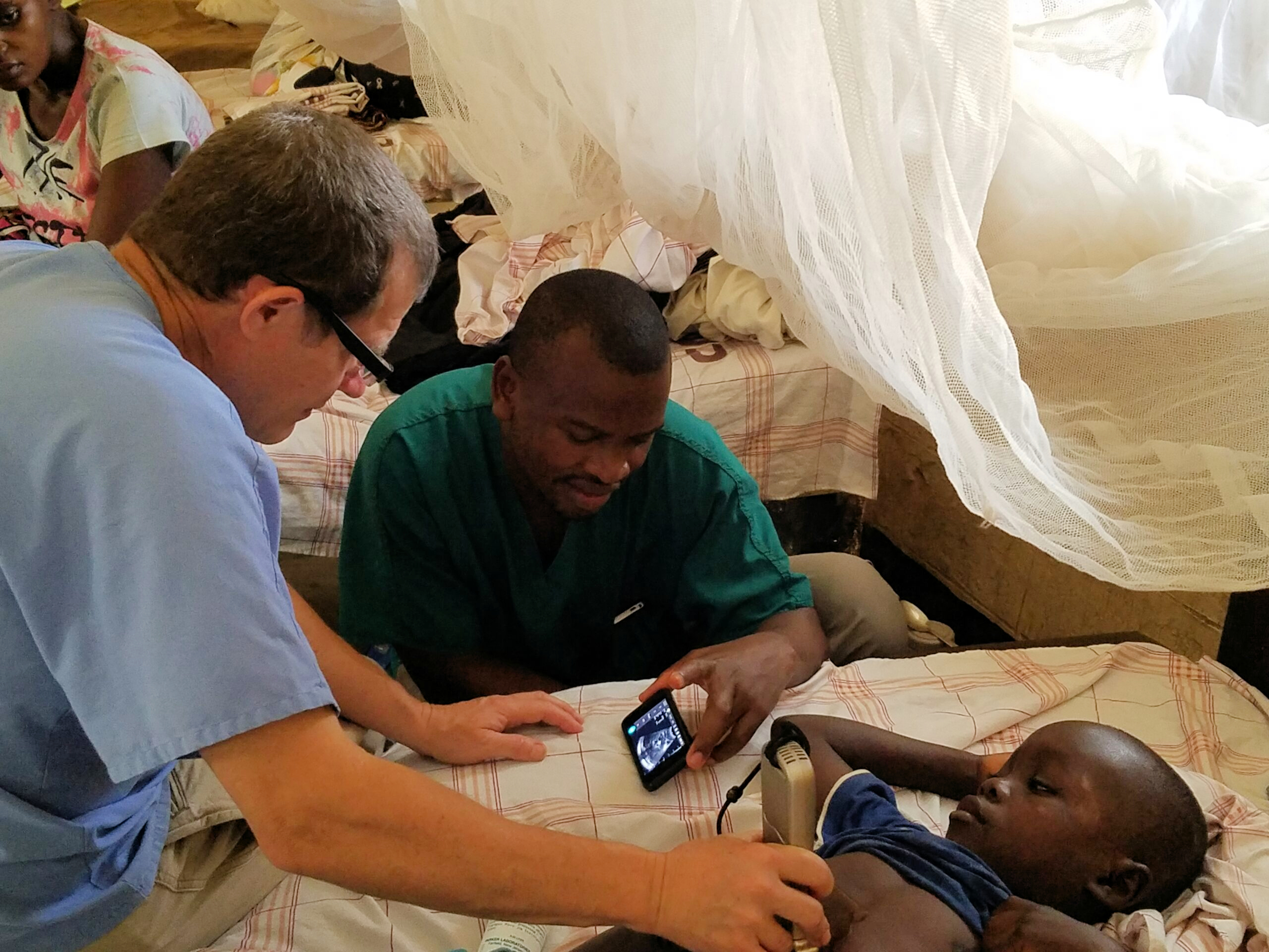 The clinical team perform an ultrasound scan at the Nyankunde Hospital, the Democratic Republic of the Congo, where Warren Cooper, MD, has performed operations ranging from repairing broken bones to craniotomies for over a decade.