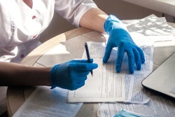 Doctor Fills Patient Medical Record 400