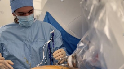 A second-year radiology resident inserts an irreversible electroporation (IRE) needle using Epione, the robotic-assisted platform from Quantum Surgical that supports interventional radiologists in treating inoperable or challenging early-stage tumors. Courtesy of Laurent Milot, MD, PhD.
