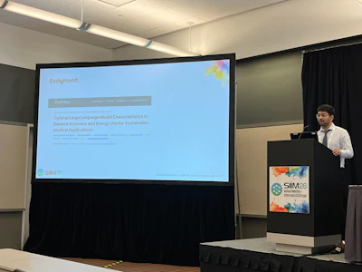Dharmam Savani presents his team's findings at SIIM 2026 showing that reasoning LLMs may not meaningfully improve radiology report labeling over standard LLMs, but do use more energy.