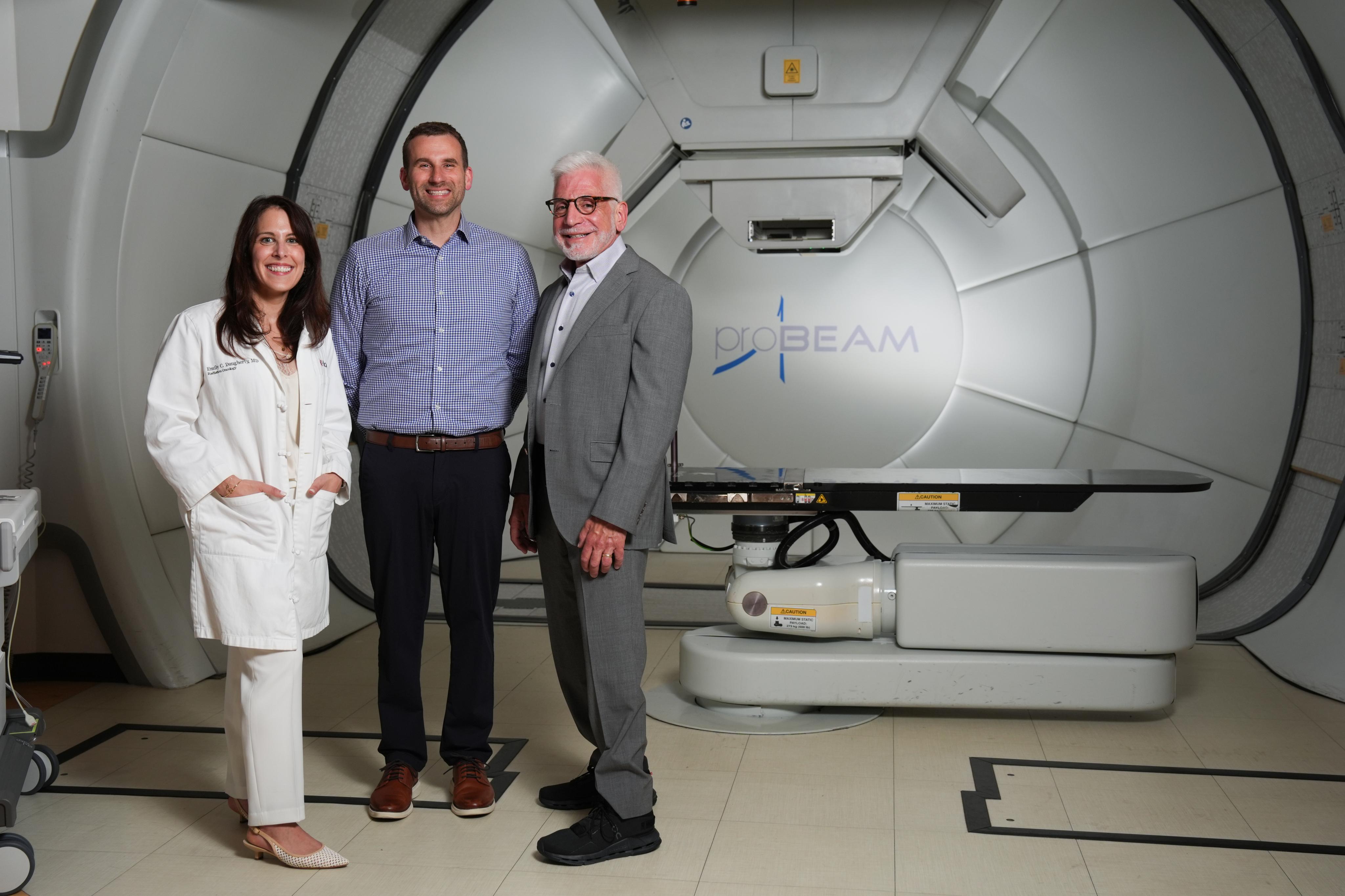 (From left to right) Researchers Emily Daugherty, MD, Anthony Mascia, PhD, and John Perentesis, MD, inside the proton therapy treatment room at the Cincinnati Children's/University of Cincinnati Medical Center Proton Therapy Center.