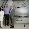 (From left to right) Researchers Emily Daugherty, MD, Anthony Mascia, PhD, and John Perentesis, MD, inside the proton therapy treatment room at the Cincinnati Children's/University of Cincinnati Medical Center Proton Therapy Center.