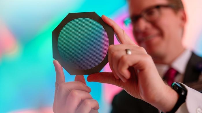 Radiation oncology medical physicist Michael Grams, MD, holds a device called a tungsten collimator that divides a conventional radiation beam into submillimeter-wide beamlets.