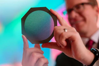 Radiation oncology medical physicist Michael Grams, MD, holds a device called a tungsten collimator that divides a conventional radiation beam into submillimeter-wide beamlets.