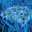 Glowing neon circuit board brain representing artificial intelligence and neural networks in blue and cyan tones