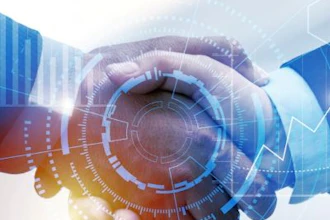 Digital handshake with blue and orange technology network patterns symbolizing business partnership and innovation