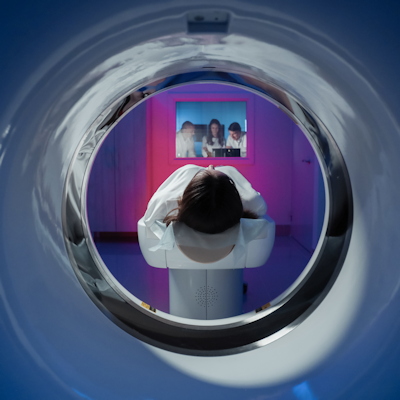 Panoramic view of person in white clothing inside purple-walled room with photo display