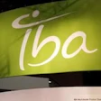 IBA brand logo with white stylized text and circular symbol on green gradient background signage