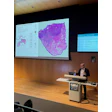 Medical researcher presenting computational pathology findings at SIIM CAIRM26 conference with tissue analysis visualization