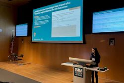 Female presenter delivering conference talk on AI and ICH outcomes at SIM event with projection screens