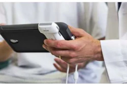 Person holding black smartphone with white charging cable in hands