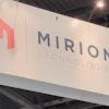 Mirion Technologies corporate logo and text displayed on white trade show booth signage