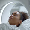 Patient relaxing inside an MRI scanner with illuminated circular ring during medical imaging procedure