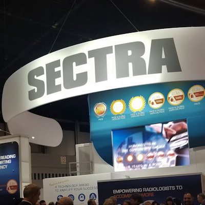 SECTRA exhibition booth with curved white signage, blue panel displays, and product imagery at a trade show