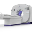 GE HealthCare CT scanner with gray housing, purple accent ring, and sliding patient table